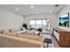 Cozy living room featuring a comfy couch, an oversized sliding door to a balcony, and a scenic view of the water at 4234 Gulf Of Mexico Dr # H2, Longboat Key, FL 34228
