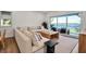 Comfortable living room with large sectional sofa, wood table, and scenic waterfront views at 4234 Gulf Of Mexico Dr # H2, Longboat Key, FL 34228