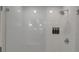 Modern shower features a glass door, white tile, a built-in niche, and a rainfall showerhead at 4234 Gulf Of Mexico Dr # H2, Longboat Key, FL 34228
