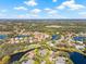 Beautiful aerial view of a home nestled within a vibrant community with lush landscaping and serene lake views at 4477 White Cedar Trl, Sarasota, FL 34238