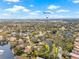 Aerial view of a neighborhood with beautiful lakes, lush trees, and proximity to beaches at 4477 White Cedar Trl, Sarasota, FL 34238