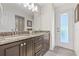 Bathroom with a granite countertop double vanity and a door leading to the backyard at 4477 White Cedar Trl, Sarasota, FL 34238