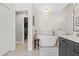 Elegant bathroom featuring a standalone tub and a view into the walk-in closet at 4477 White Cedar Trl, Sarasota, FL 34238