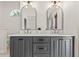 Modern bathroom featuring a double vanity with gray cabinetry and arched mirrors at 4477 White Cedar Trl, Sarasota, FL 34238
