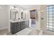 Beautiful bathroom with a double vanity and glass block shower near an exterior exit at 4477 White Cedar Trl, Sarasota, FL 34238