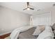 Cozy bedroom featuring plush bedding, ceiling fan, and a double-door closet at 4477 White Cedar Trl, Sarasota, FL 34238