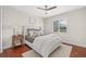 Inviting bedroom with a comfortable bed, wood floors, and ample natural light at 4477 White Cedar Trl, Sarasota, FL 34238