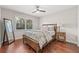 Bright bedroom features a large window with plantation shutters and a full-length mirror, offering style and comfort at 4477 White Cedar Trl, Sarasota, FL 34238