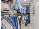 Spacious walk-in closet with custom shelving and ample storage space at 4477 White Cedar Trl, Sarasota, FL 34238