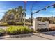 The Deer Creek community entrance is marked with stone signage, lush landscaping, and a well-maintained traffic light at 4477 White Cedar Trl, Sarasota, FL 34238