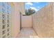 Private courtyard with tiled floor and a unique glass block wall for natural light at 4477 White Cedar Trl, Sarasota, FL 34238