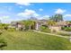 A well-maintained home boasts lush green grass, palm trees, a brick driveway, and a two-car garage at 4477 White Cedar Trl, Sarasota, FL 34238