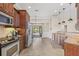 Well-lit kitchen featuring stainless steel appliances, granite countertops, and seamless access to the outdoor patio at 4477 White Cedar Trl, Sarasota, FL 34238