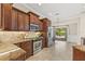 Updated kitchen with granite countertops, stainless steel appliances, and dark wood cabinetry at 4477 White Cedar Trl, Sarasota, FL 34238
