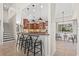 Stylish kitchen bar with pendant lighting and seating, open to the adjacent dining and living areas at 4477 White Cedar Trl, Sarasota, FL 34238