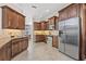 Spacious kitchen with stainless steel appliances, granite countertops, and dark wood cabinets at 4477 White Cedar Trl, Sarasota, FL 34238