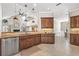 Well-lit kitchen with granite countertops, stainless steel appliances, and dark wood cabinetry at 4477 White Cedar Trl, Sarasota, FL 34238