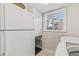 This laundry area features ample cabinet space, a window for natural light, and modern appliances for convenience at 4477 White Cedar Trl, Sarasota, FL 34238