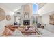 Comfortable living room featuring a fireplace, large windows, plantation shutters, and ample seating at 4477 White Cedar Trl, Sarasota, FL 34238