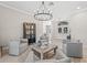 The living room with tile floors, neutral-toned furnishings, and a view of the front entrance at 4477 White Cedar Trl, Sarasota, FL 34238