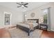 Well-lit main bedroom showcasing hardwood floors, neutral walls, and stylish decor at 4477 White Cedar Trl, Sarasota, FL 34238