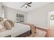 Comfortable main bedroom featuring hardwood floors, large windows, and a ceiling fan at 4477 White Cedar Trl, Sarasota, FL 34238