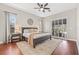 Cozy main bedroom with a king bed, ceiling fan, and natural light from windows and patio access at 4477 White Cedar Trl, Sarasota, FL 34238