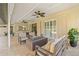 Covered lanai with outdoor seating and a fire pit, providing a relaxing space overlooking the pool at 4477 White Cedar Trl, Sarasota, FL 34238