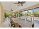 Spacious screened patio with an outdoor dining area and comfortable seating, perfect for entertaining by the pool at 4477 White Cedar Trl, Sarasota, FL 34238