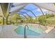 Lovely screened-in pool with ample lounging space on the tiled deck, offering a refreshing escape at 4477 White Cedar Trl, Sarasota, FL 34238