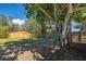 Private backyard showcasing a sturdy wooden fence and a huge tree, offering both security and natural beauty at 470 Leach St, Englewood, FL 34223