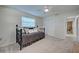 A bedroom featuring soft carpet, a dark bed frame and a ceiling fan at 470 Leach St, Englewood, FL 34223