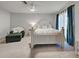 A bedroom with a white bed, chaise lounge and a ceiling fan at 470 Leach St, Englewood, FL 34223