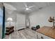 Well-lit bedroom with wood-look flooring and a white ceiling fan offers a calm, comfortable atmosphere at 470 Leach St, Englewood, FL 34223