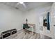 Bedroom with wood-look floors, a ceiling fan, and view to the dining area at 470 Leach St, Englewood, FL 34223