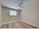 This bedroom has beautiful wood-look flooring and a ceiling fan, creating a cozy atmosphere at 470 Leach St, Englewood, FL 34223