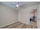 Bright bedroom features wood-look floors, a ceiling fan, and convenient access to another room at 470 Leach St, Englewood, FL 34223