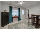 Bright dining area features a ceiling fan, tile flooring, and elegant furniture at 470 Leach St, Englewood, FL 34223