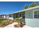 Inviting home with a screened porch, complemented by a walkway and lush landscaping at 470 Leach St, Englewood, FL 34223