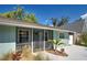 Inviting front entrance with a secure screen door, neat landscaping, and light blue painted siding at 470 Leach St, Englewood, FL 34223