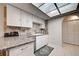 Well-equipped kitchen with ample counter space, natural stone backsplash, and modern appliances at 470 Leach St, Englewood, FL 34223