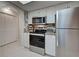Bright kitchen with white cabinets, stainless steel appliances, and granite countertops at 470 Leach St, Englewood, FL 34223