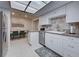 A well-lit kitchen boasts white cabinetry, stainless steel appliances and eat-in breakfast area at 470 Leach St, Englewood, FL 34223