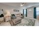 Comfortable living room featuring a plush sofa, decorative rug, and a front door with teal curtains at 470 Leach St, Englewood, FL 34223