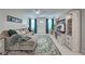 Open-concept living room with cozy seating, stylish entertainment center, and view of the entrance at 470 Leach St, Englewood, FL 34223