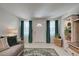 Comfortable living room featuring a plush sofa, teal drapes, and tiled flooring at 470 Leach St, Englewood, FL 34223