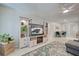 Bright living room with a decorative entertainment center, electric fireplace and a view into the dining area at 470 Leach St, Englewood, FL 34223