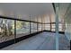 Spacious screened patio with concrete flooring, black supports, and backyard view at 470 Leach St, Englewood, FL 34223