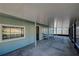 Covered patio with concrete flooring, green siding, and view into the screened patio at 470 Leach St, Englewood, FL 34223