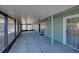 Relaxing covered patio features concrete flooring, exterior door, and view of the backyard at 470 Leach St, Englewood, FL 34223